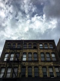 Low angle view of building against cloudy sky