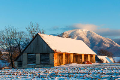 House covered with snow against sky