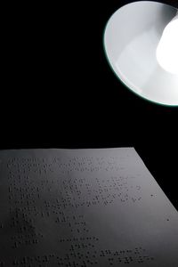 Low angle view of illuminated lighting equipment on table