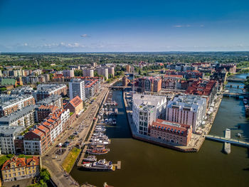High angle view of buildings by sea against sky aerial view of the new apartments in gdansk poland 