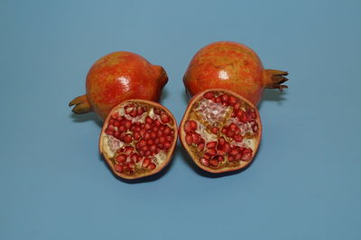 Pomegranate fruits on blue background