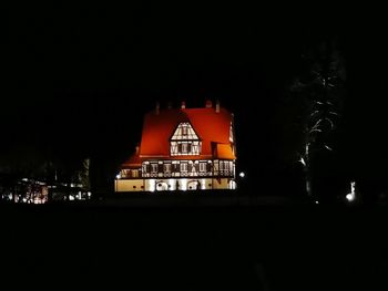 Illuminated building against sky at night