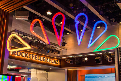 Low angle view of illuminated lighting equipment at restaurant