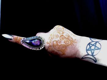 Close-up of human hand against black background