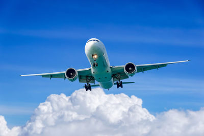 Low angle view of airplane flying in sky