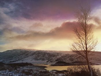 Scenic view of snowcapped mountains against sky during sunset