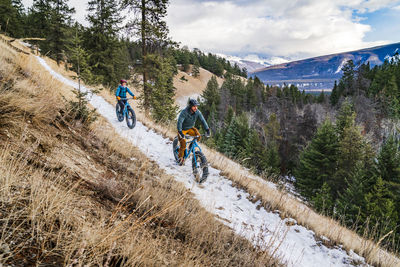 Couple fat biking winter trails in jasper national park