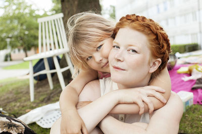 Portrait of smiling mother with daughter