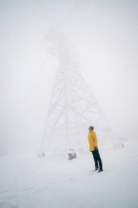 Person standing on snow covered landscape