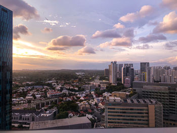 High angle view of city buildings against sky during sunset