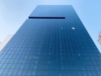 Low angle view of modern building against clear blue sky