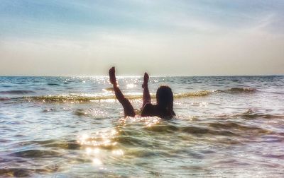 Man surfing on sea against sky