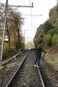 View of railway tracks along trees