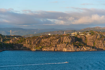 Scenic view of sea and mountains against sky