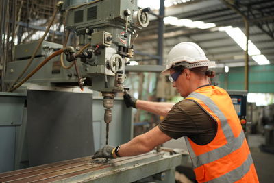 Rear view of man working in factory