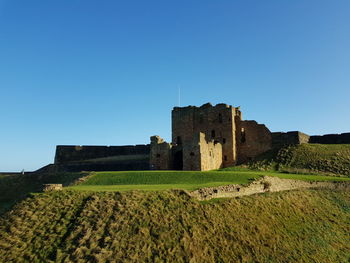 Northumbrian castle against clear blue sky