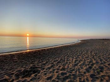 Scenic view of sea against clear sky during sunset