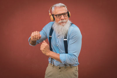 Portrait of young man lifting dumbbell in gym