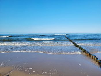 Scenic view of sea against clear blue sky