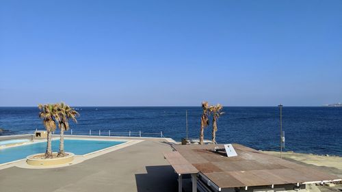 Scenic view of sea against clear blue sky