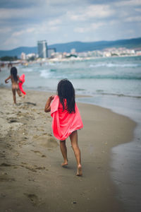 Rear view of women on beach