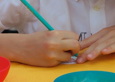 Close-up of boy holding hands