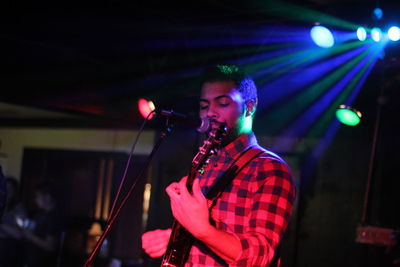 Young man performing at nightclub