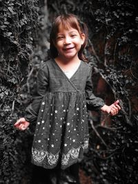 Portrait of smiling girl standing outdoors