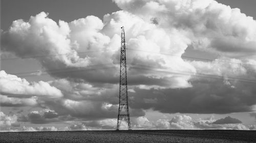 Low angle view of electricity pylon against sky