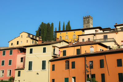 Low angle view of buildings against blue sky