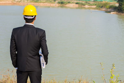 Rear view of man standing in water