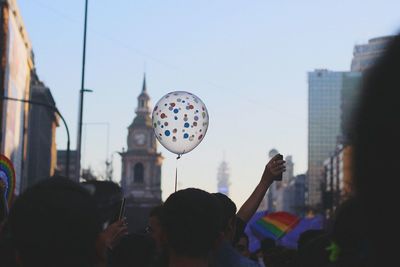 People on city street against sky