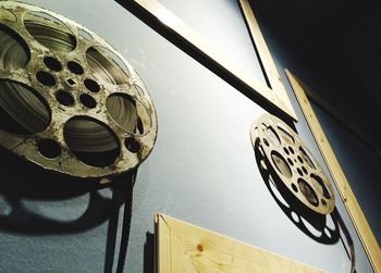 Low angle view of old film reels on wall