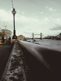 Tower bridge in city against sky