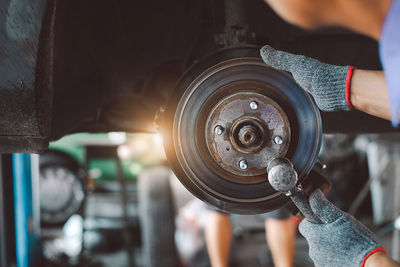 Midsection of man repairing car