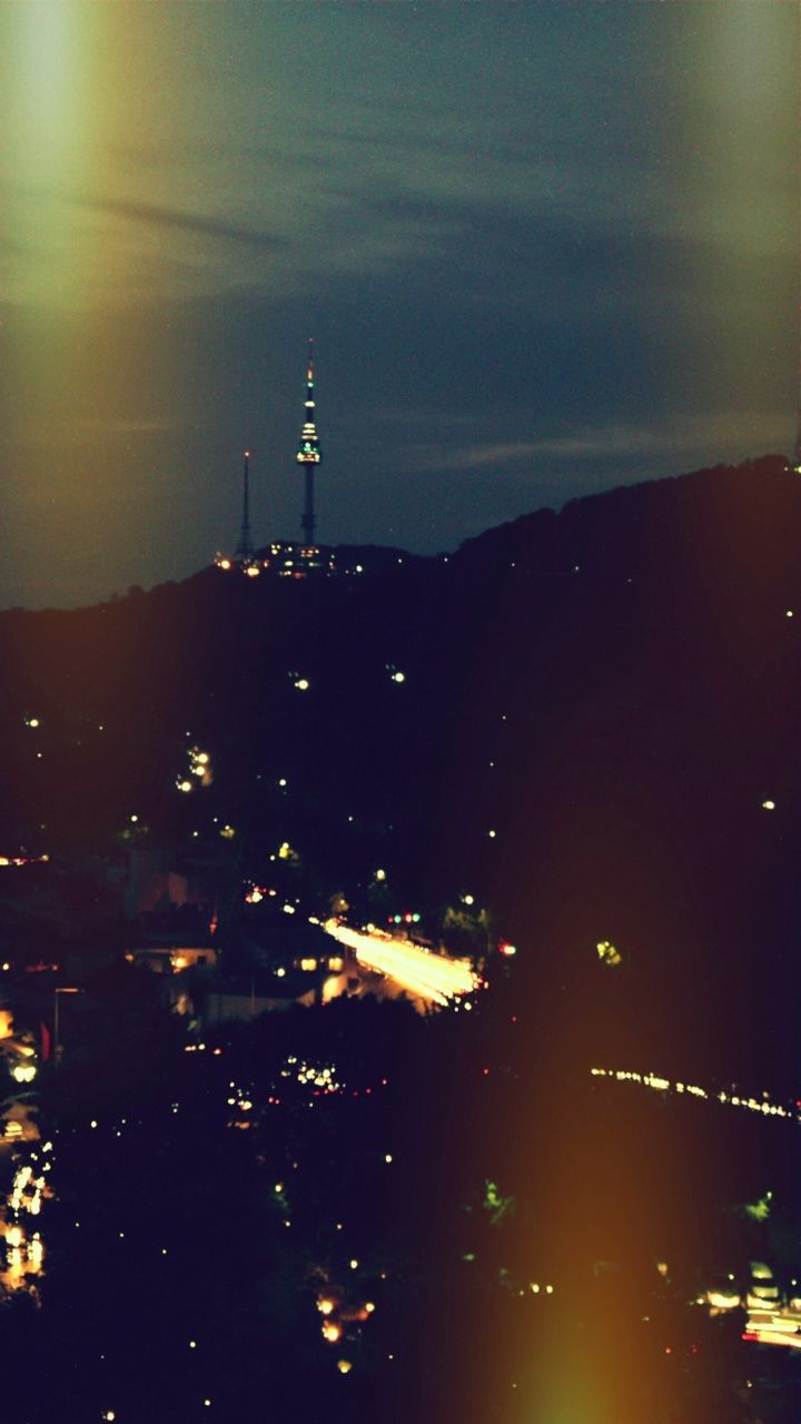 illuminated, communications tower, building exterior, tower, city, built structure, architecture, tall - high, sky, night, spire, international landmark, cityscape, travel destinations, capital cities, communication, dusk, famous place, tourism, skyscraper