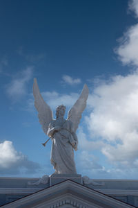 Low angle view of statue against sky