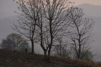 Woman standing on dirt road