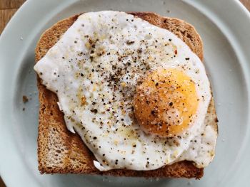 High angle view of bread with fried egg on plate