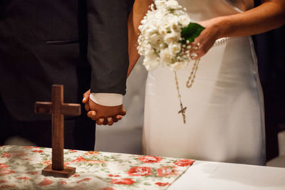 Bride and groom holding hands during wedding ceremony