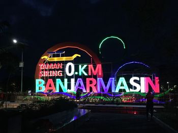 Illuminated information sign in city at night