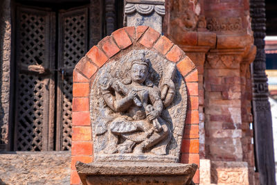 Statue against historic building