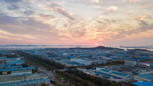 High angle view of cityscape against blue sky during sunset