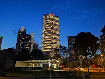 Low angle view of illuminated buildings against sky at dusk