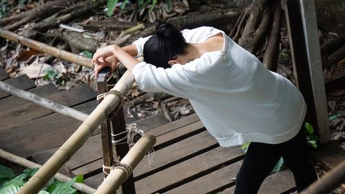 High angle view of woman lying on wood