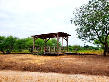 Built structure on field against sky