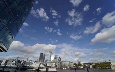 Low angle view of buildings against cloudy sky