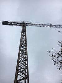 Low angle view of crane against sky