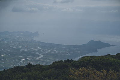 Scenic view of sea and mountains against sky