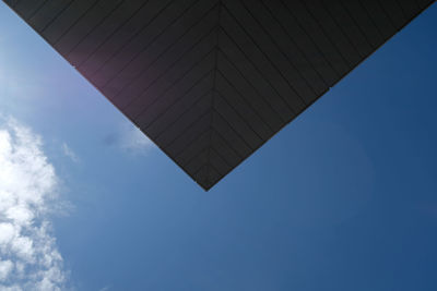 Low angle view of modern built structure against blue sky